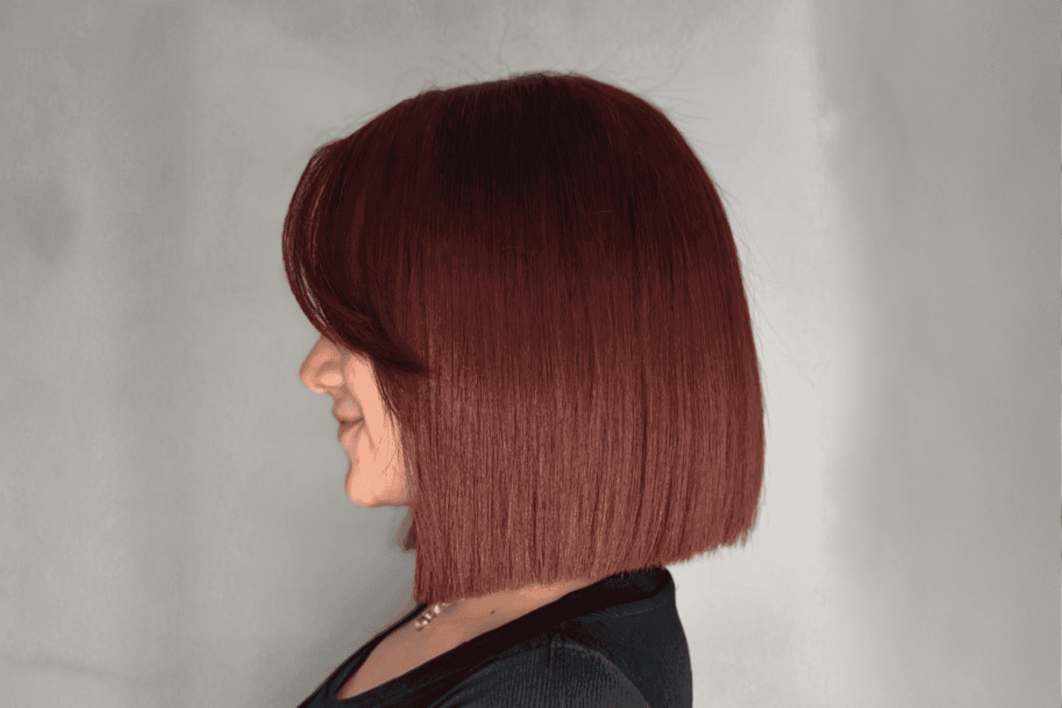 Short bob hairstyle with red hair, viewed from the side.